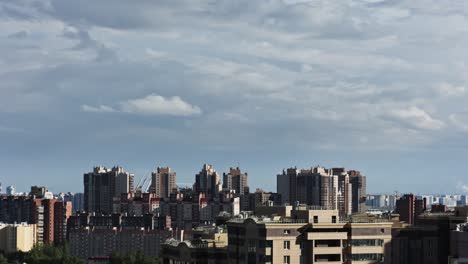 city view with modern buildings, clouds over the city