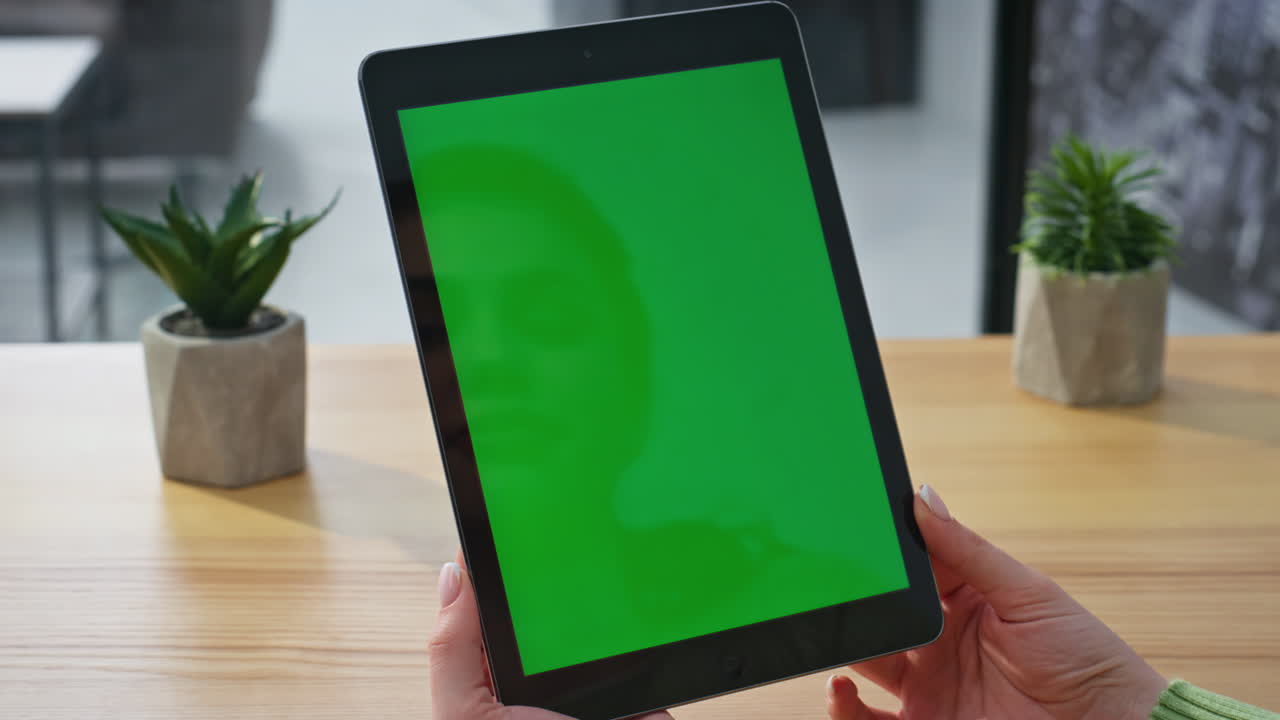 Lady hands holding chromakey pad at office closeup. Woman using mockup tablet