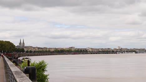 scenic riverfront with city skyline and clouds