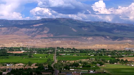 grand mesa grand junction aerial drone afternoon cloudy colorado river summer blue sky wine vineyards parachute fruitvale mt garfield western close delta downtown main street backwards motion