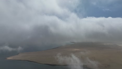 cinematic shot of white clouds over wide lands on sea, lima, peru