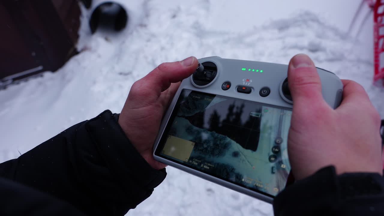 Drone Controller Displaying Live Feed with Snowy Background