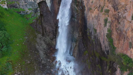 Aerial-shot-of-Barskoon-Waterfall-in-Fairy-Tale-Canyon-in-Kyrgyzstan,-focusing-on-the-lower-part-of-the-falls