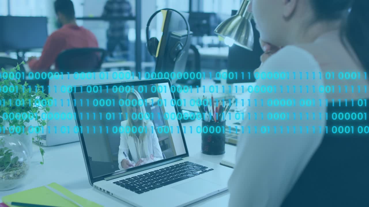 Woman watching laptop while remote host speaking, binary digits overlaying laptop showing security