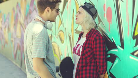 Couple-of-young-skateboards-standing-chatting