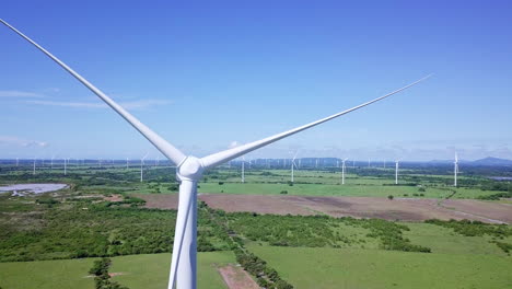 aerial view of wind turbine, trees, on sunny day