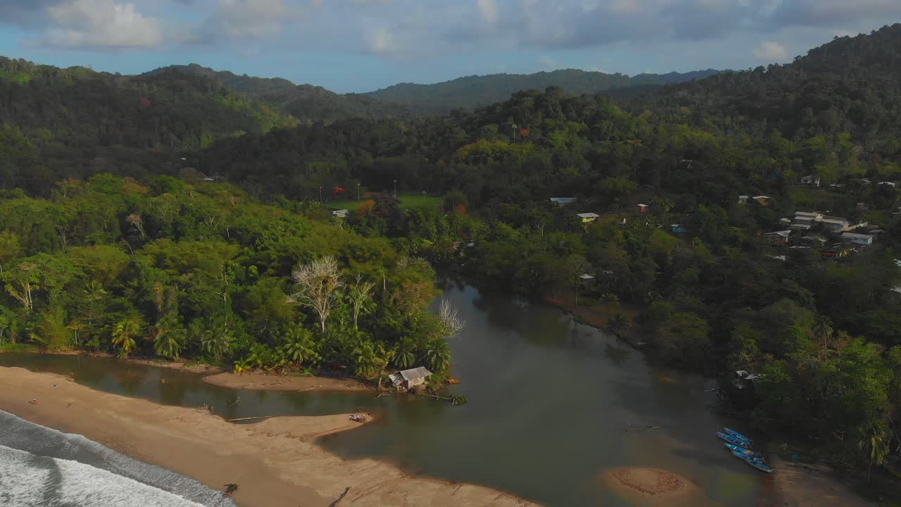 Fishing boats alongside this epic north coast beach Grande Riviere as the river flows from the rainforest into the sea on the Caribbean island of Trinidad