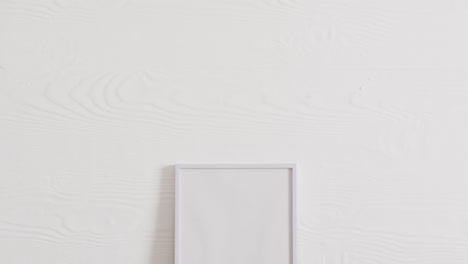 white frame with copy space on white background and white wall