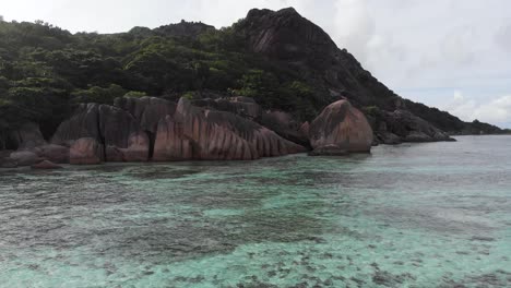 Aerial-view-of-Anse-Source-d’Argent,-La-Digue,-Seychelles-shot-in-the-early-morning-hours-with-no-people-on-the-beach