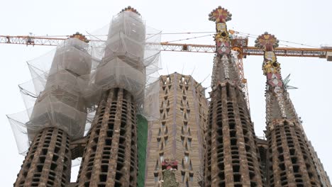 Close-up-view-of-the-Sagrada-Familia-towers,-the-largest-unfinished-Catholic-church-in-the-world,-and-part-of-a-UNESCO-World-Heritage-Site