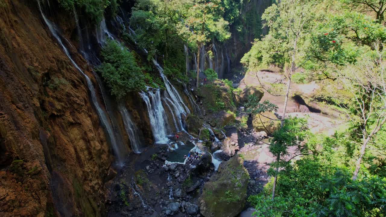 Majestic Tumpak Sewu waterfall flows under Java's Semeru volcano