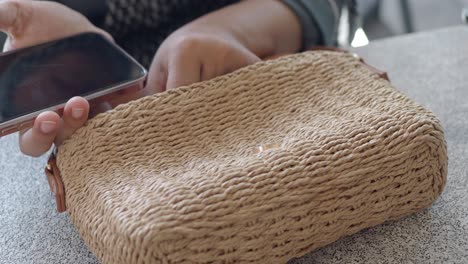 close-up of a woven straw handbag