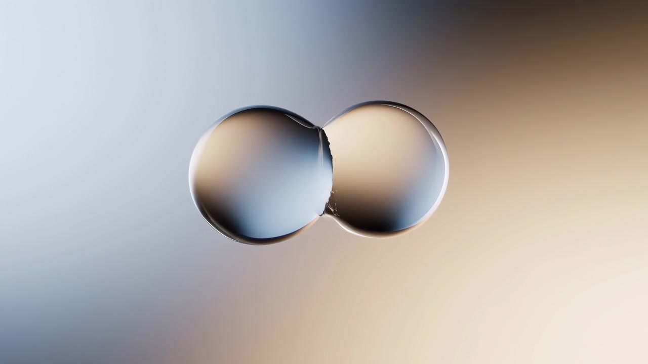 Two glossy reflective spheres remain near the upper center of the frame throughout the sequence, floating against a smooth cool-to-warm gradient background