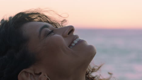 close up portrait of beautiful hispanic woman looking up exploring mindfulness contemplating spirituality with wind blowing hair enjoying peaceful seaside at sunset