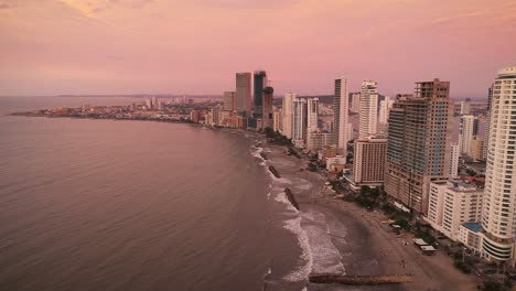 an aerial shot of the sun setting on the skyline of cartagena, colombia