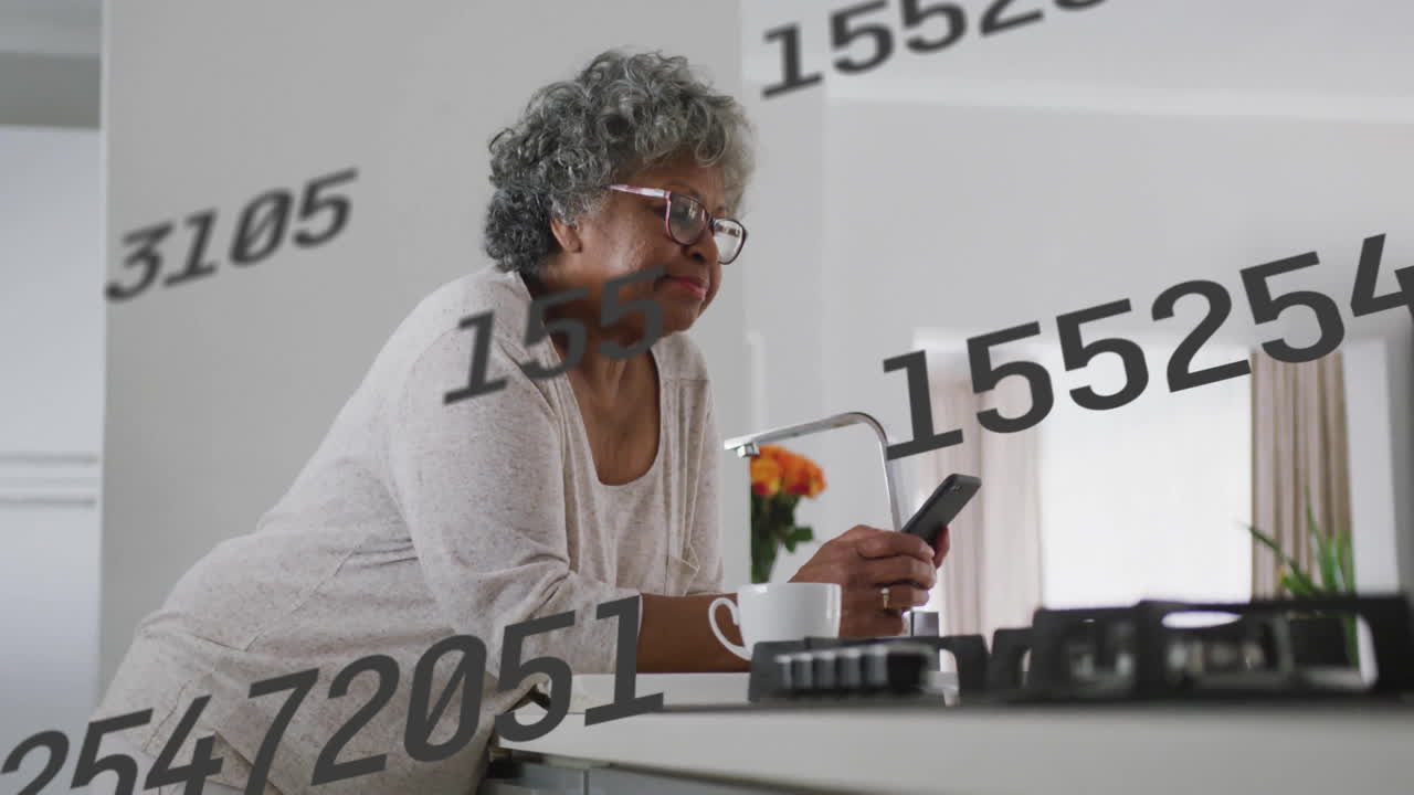 Elderly woman using smartphone in kitchen with floating numbers animation overlay