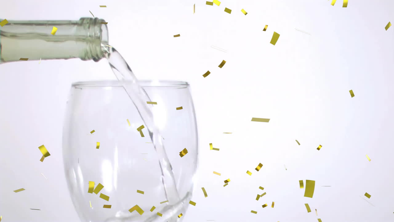 Animation of confetti over glass of white wine on white background