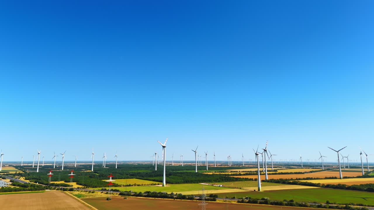 Numerous modern wind turbines in the fields. Energy production concept from nature