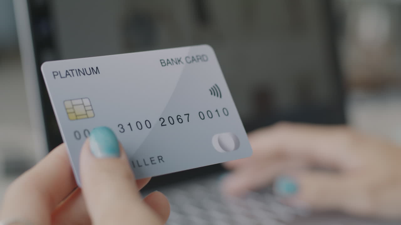 Woman using credit card on laptop for online payment