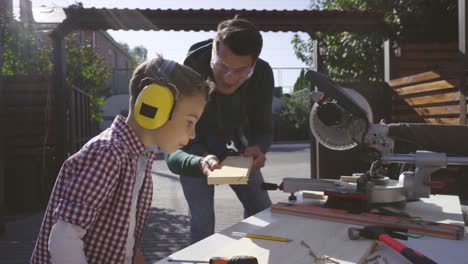 the father and son doing carpentry outdoor. slow motion