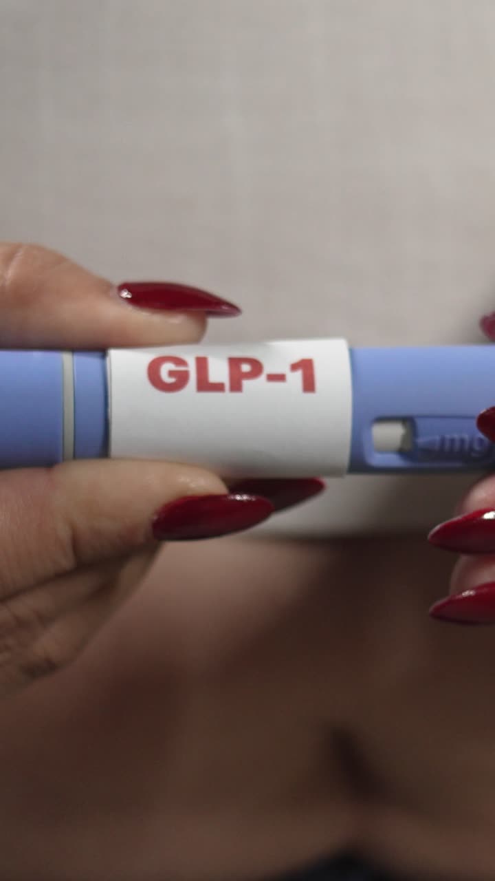 Overweight woman holding a GLP-1 injection pen at home, weight control and insulin resistance care