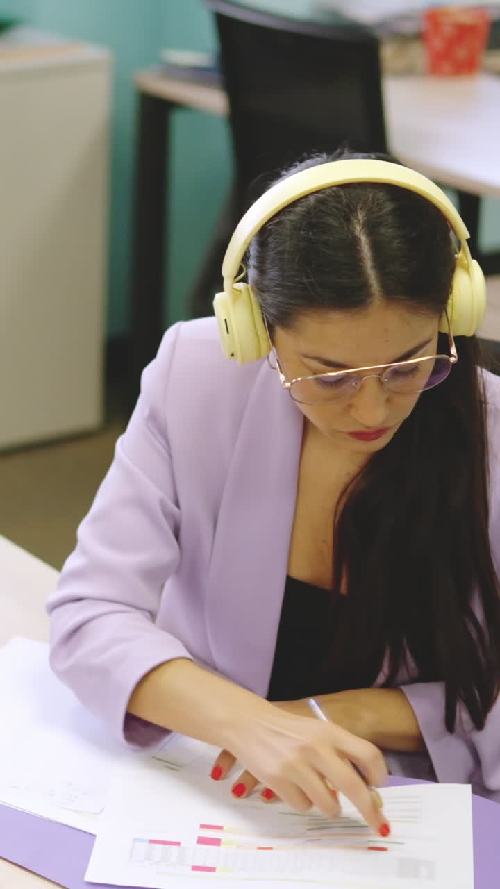Concentrated woman working in paperwork in a modern coworking