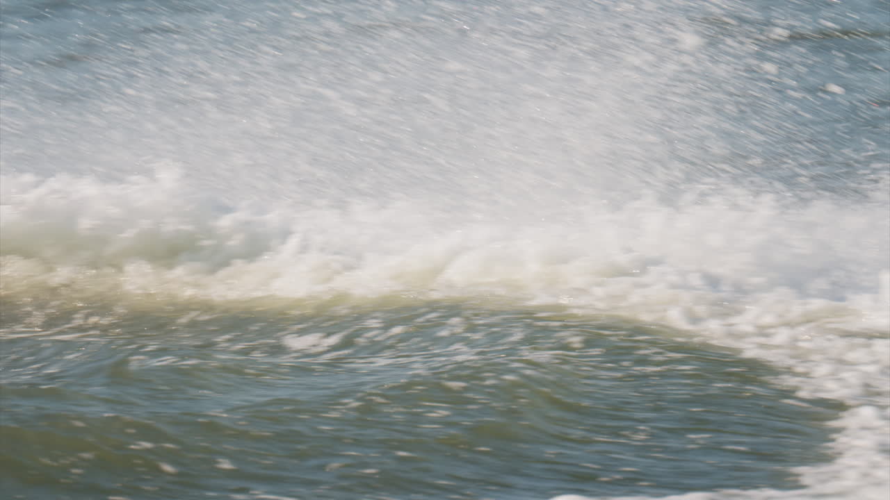 Water being splashed around by a jet ski moving at high speed across a calm body of water