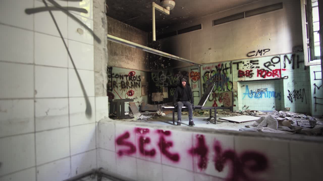 man black dressed sleep in abandoned asylum