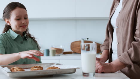 grandma and girl eating a cookie