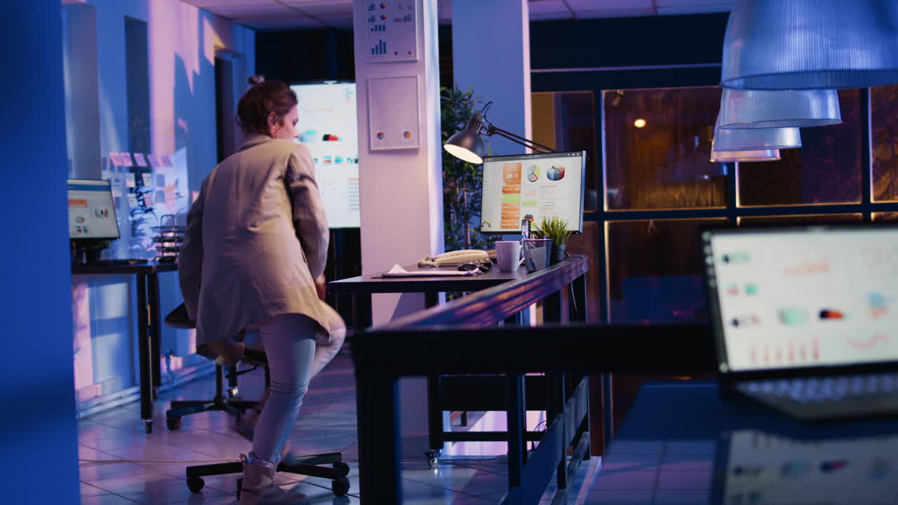Woman working on computer at desk in office