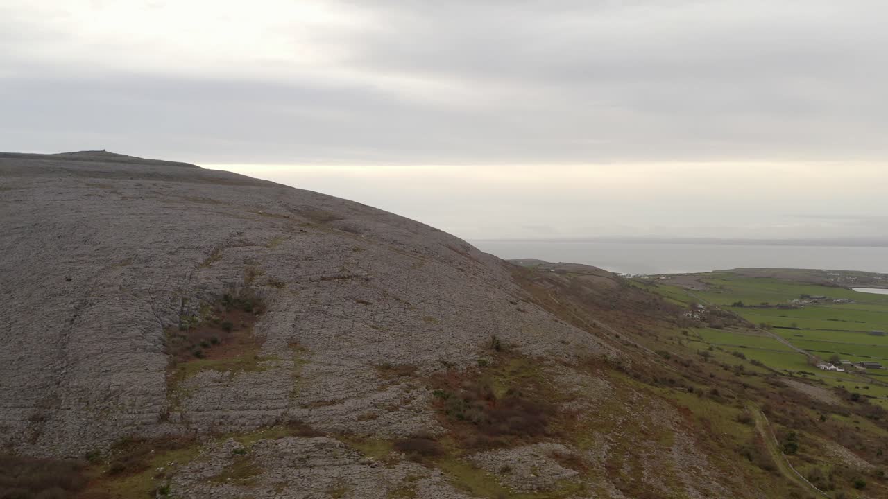 Cinematic aerial, Burren's rocky hill, vibrant autumn hues Ireland
