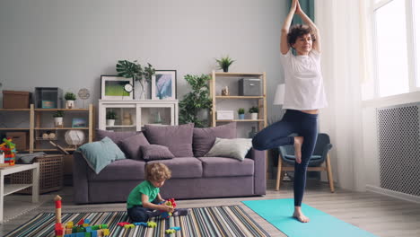 mother and child practicing yoga at home