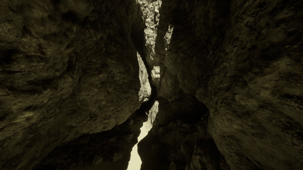 Exploring a narrow canyon with towering rock formations and bright sunlight