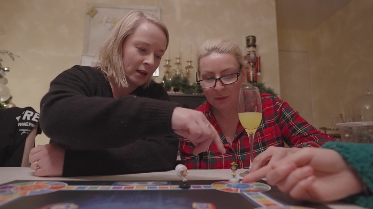 Christmas board game festive fun, competitive Mother and daughter