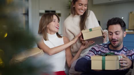 video of friends exchanging gifts on christmas