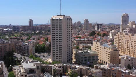 aerial view of a cityscape with a prominent skyscraper