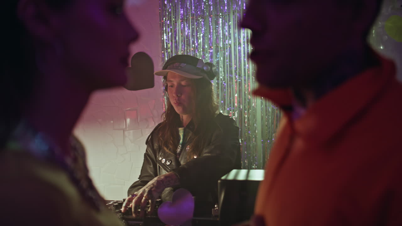 Dj entertain club crowd at night party. Woman disk jockey performing music