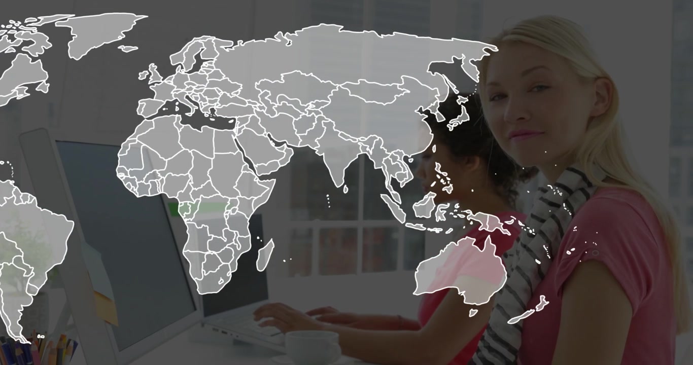 Team typing at screens outline appearing and world map overlay growing over desk for business