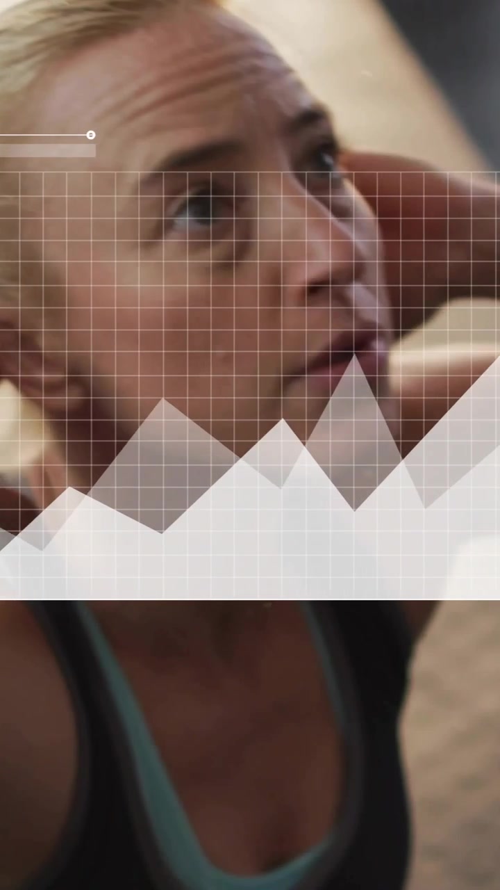 Vertical video: Woman doing crunches while camera revealing HUD charts tracking fitness progress