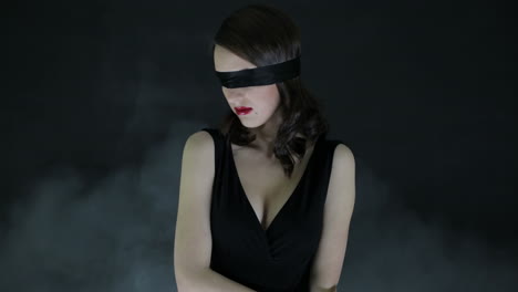 woman with blindfold in black dress