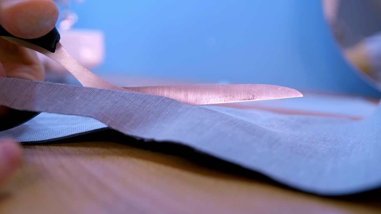 Close-up of a Seamstress's Workshop: Focused on Fabric Preparation as the Needle and Thread Await the Creative Process to Begin