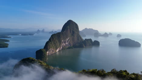 limestone islands in tranquil water of phang nga bay in thailand. - aerial shot