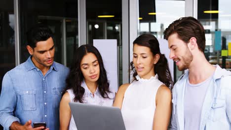 Executives-having-discussion-over-laptop