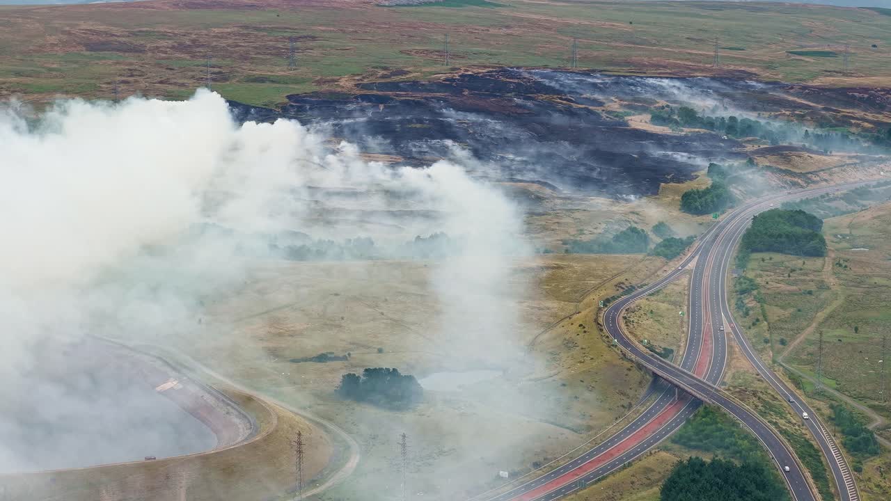 Aerial drone view of a large grass fire burning on moorland in the Welsh valleys