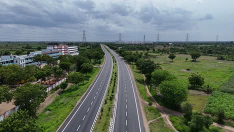 scenic highway in chennai bordered by green spaces, blending nature with infrastructure