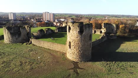 ancient flint castle medieval heritage military welsh ruins aerial view landmark closeup to pull away left