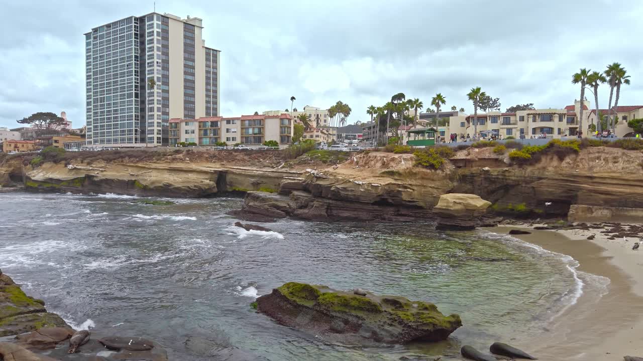 Birds fly and ocean waves flowing to the shore on La Jolla affluent in San Diego