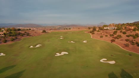 Vista-Aérea-Del-Paisaje-De-Un-Campo-De-Golf-Con-Trampas-De-Arena-Durante-Un-Torneo