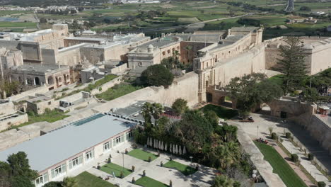 drone shot of the ditch, fortification walls and medieval city of mdina, malta