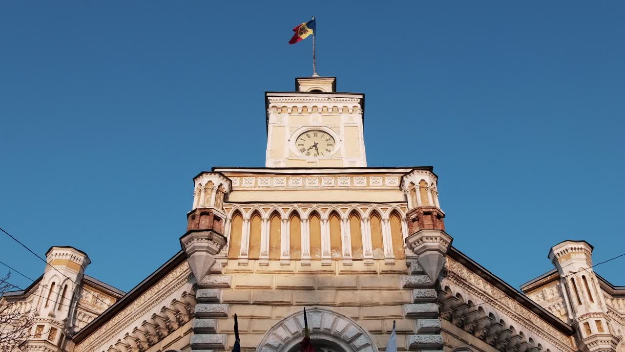 The flag of Moldova waving on top of the Chisinau City Hall in the city center